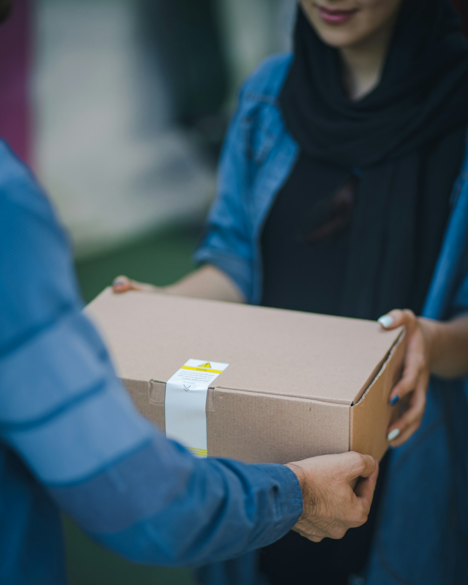 Carefully packed parcel being handed to a customer